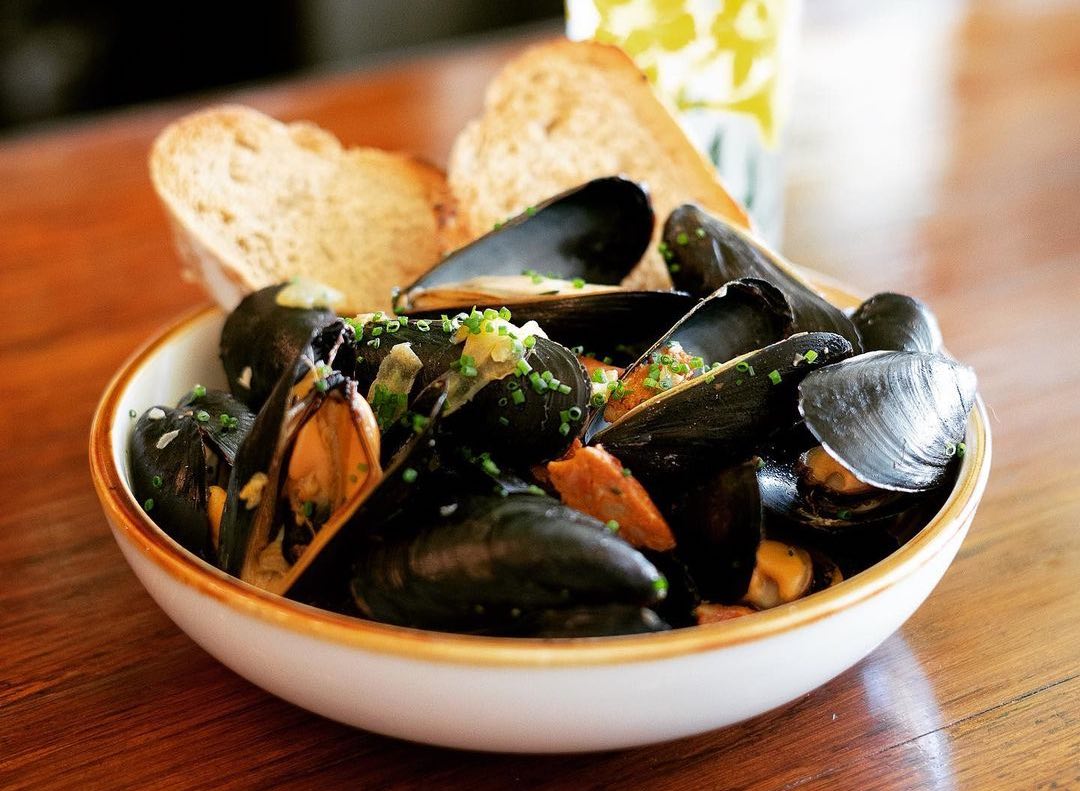 bowl of steamed mussels on a bar